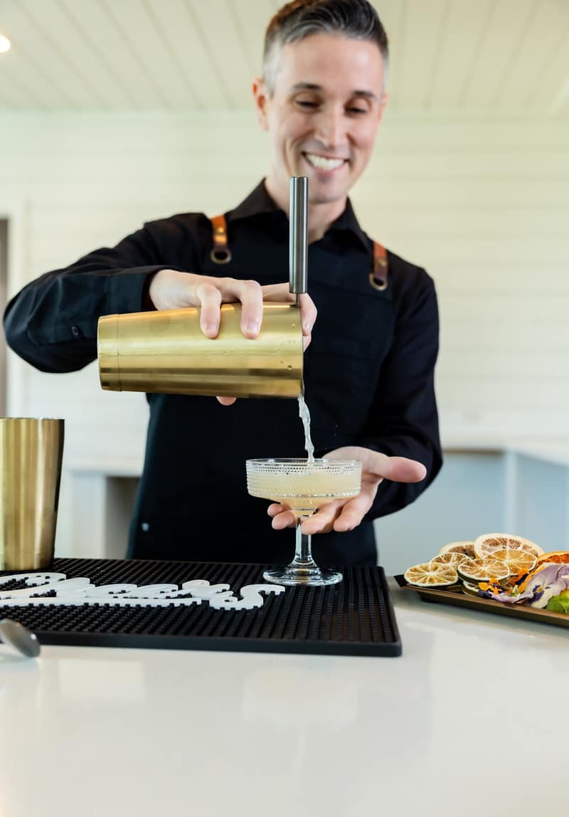 Shaker bartender straining a freshly shaken cocktail