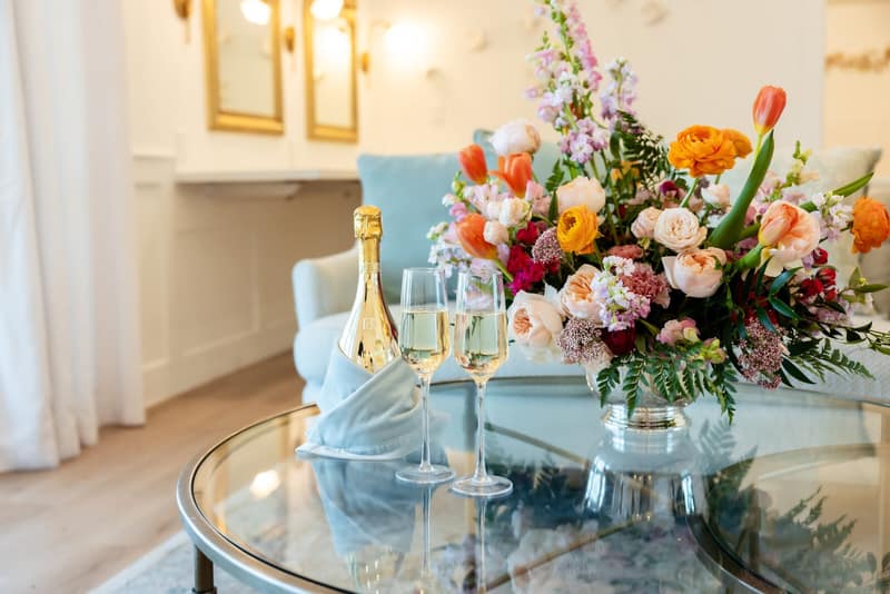 Champagne service set up in a bridal suite with fresh florals