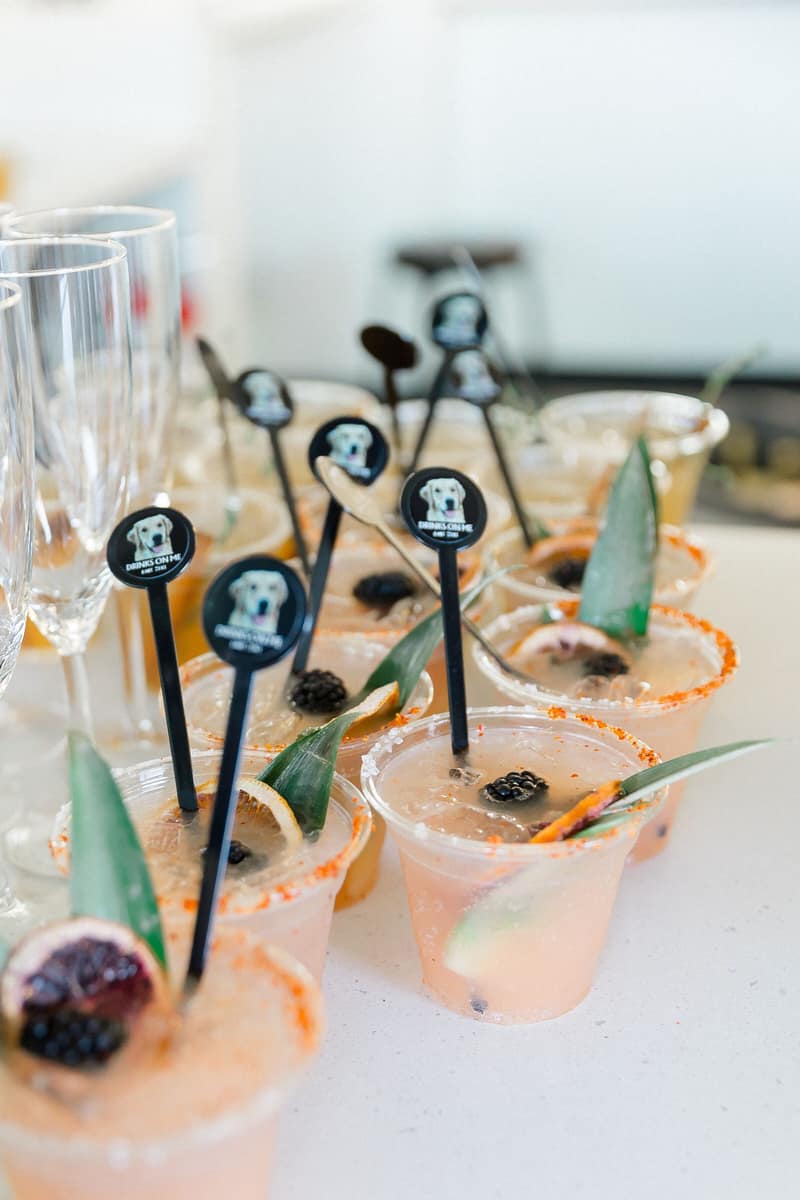 Cocktails garnished with blackberries and custom drink picks