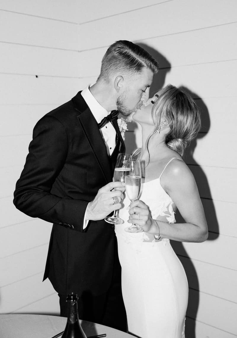 Black and white photograph of a couple toasting with champagne flutes