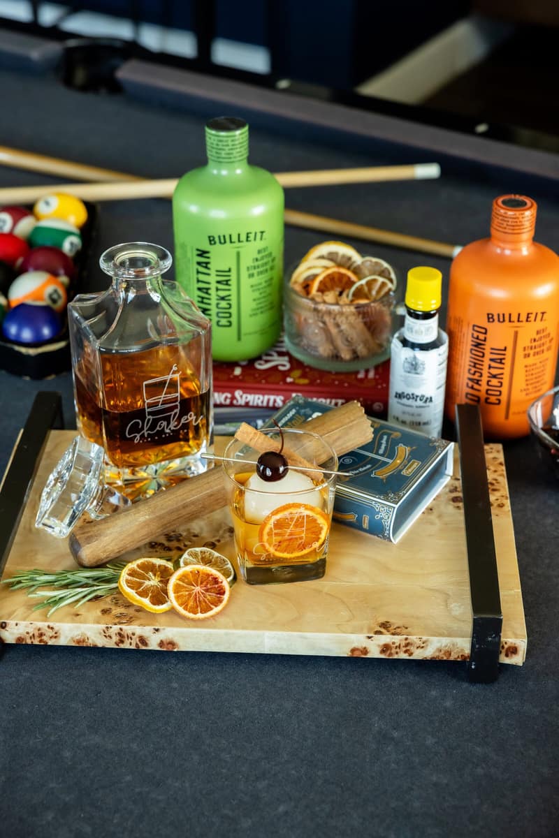 Smoked old fashioned station with whiskey bottles on a games table