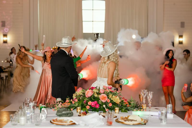 Wedding head table set with cocktails during a lively Texas reception